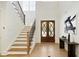 Bright foyer with hardwood floors, staircase, and elegant double doors at 4059 Yellow Creek Trl, Cumming, GA 30028