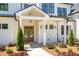 Inviting front porch with stylish lighting and stone pathway, perfect for relaxing at 4059 Yellow Creek Trl, Cumming, GA 30028