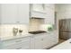 Bright kitchen with gas range, quartz counters, tile backsplash and custom cabinets at 4059 Yellow Creek Trl, Cumming, GA 30028
