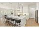 Bright kitchen with island, pendant lighting, stainless appliances and breakfast area at 4059 Yellow Creek Trl, Cumming, GA 30028