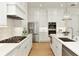 Bright kitchen with stainless appliances, quartz counters, tile backsplash and custom cabinets at 4059 Yellow Creek Trl, Cumming, GA 30028