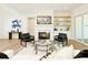 Elegant living room features a fireplace, comfortable seating, and built-in shelving at 4059 Yellow Creek Trl, Cumming, GA 30028