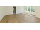 Bright living room featuring hardwood floors and an abundance of natural light from large windows at 4059 Yellow Creek Trl, Cumming, GA 30028