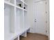 Mud room with custom storage, seating and tile floor at 4059 Yellow Creek Trl, Cumming, GA 30028