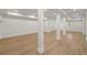 Large basement space with wood flooring and support beams at 4477 Jett Nw Rd, Atlanta, GA 30327