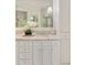 Bright bathroom vanity featuring granite counters, double sinks, and white cabinets at 4477 Jett Nw Rd, Atlanta, GA 30327