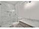 Bathroom with marble tile walk-in shower, gray vanity, and modern fixtures offering luxurious feel at 4477 Jett Nw Rd, Atlanta, GA 30327