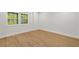 Bedroom featuring wood-look floors and large windows providing ample natural light at 4477 Jett Nw Rd, Atlanta, GA 30327