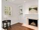 Cozy bedroom featuring a fireplace, hardwood floors, and built-in shelving at 4477 Jett Nw Rd, Atlanta, GA 30327