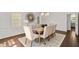 Spacious dining room with a long table, hardwood floors and a stylish light fixture, great for gatherings at 4477 Jett Nw Rd, Atlanta, GA 30327