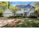 Charming two-story home featuring a lush landscaped yard, attached garage and inviting front porch at 4477 Jett Nw Rd, Atlanta, GA 30327