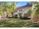 Inviting two-story home with green lawn, brick driveway and lush trees offering curb appeal and a welcoming ambiance at 4477 Jett Nw Rd, Atlanta, GA 30327