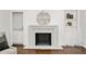 Living room fireplace with marble hearth and built-in shelves and cabinets at 4477 Jett Nw Rd, Atlanta, GA 30327