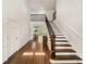 Grand two-story foyer with hardwood floors, elegant staircase, and views of the kitchen at 4477 Jett Nw Rd, Atlanta, GA 30327