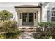 Elegant double doors with a stone pathway, stone steps and manicured shrubs creating a warm and inviting entrance at 4477 Jett Nw Rd, Atlanta, GA 30327
