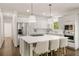 Modern kitchen featuring a large island with seating, stainless steel appliances and white cabinets providing ample storage at 4477 Jett Nw Rd, Atlanta, GA 30327
