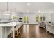 Spacious open-concept living and kitchen area with breakfast bar and hardwood floors at 4477 Jett Nw Rd, Atlanta, GA 30327