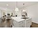 Open-concept kitchen island with stove and view of living space with stairs at 4477 Jett Nw Rd, Atlanta, GA 30327