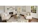 Bright living room with a decorative fireplace, hardwood floors, and large windows allowing ample natural light at 4477 Jett Nw Rd, Atlanta, GA 30327