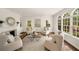 Bright and airy living room with fireplace, lots of natural light, and elegant decor with beautiful hardwood floors at 4477 Jett Nw Rd, Atlanta, GA 30327