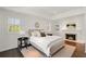 Bright bedroom featuring a fireplace, hardwood floors, and a bay window at 4477 Jett Nw Rd, Atlanta, GA 30327