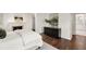 Spacious bedroom featuring hardwood floors, a fireplace, and a modern dresser, offering style and function at 4477 Jett Nw Rd, Atlanta, GA 30327