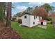 Rear exterior of a white brick home featuring a deck, level yard, mature trees and privacy at 3826 Ensign Dr, Chamblee, GA 30341