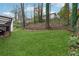 Well-maintained backyard with lush green grass, mature trees, and gentle slope, creating a serene outdoor oasis at 3826 Ensign Dr, Chamblee, GA 30341