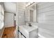 Well-lit bathroom featuring a modern vanity with horizontal shiplap and updated fixtures at 3826 Ensign Dr, Chamblee, GA 30341