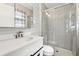 A modern bathroom with a glass-enclosed shower, vanity, and ample lighting at 3826 Ensign Dr, Chamblee, GA 30341