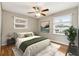 Cozy bedroom featuring natural light, a ceiling fan, and hardwood flooring at 3826 Ensign Dr, Chamblee, GA 30341