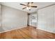 A spacious bedroom with hardwood floors, a ceiling fan, and a large closet at 3826 Ensign Dr, Chamblee, GA 30341