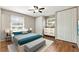A staged bedroom with hardwood floors, a comfortable bed, and ample closet space at 3826 Ensign Dr, Chamblee, GA 30341