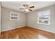 Bright bedroom with hardwood floors, ceiling fan, and natural light from two windows at 3826 Ensign Dr, Chamblee, GA 30341