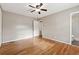 A comfortable bedroom with hardwood floors and a view into the bathroom at 3826 Ensign Dr, Chamblee, GA 30341