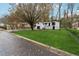 Two-story home showcasing a well-maintained lawn, mature trees, and lovely exterior on a quiet street at 3826 Ensign Dr, Chamblee, GA 30341