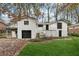 Charming two-story home featuring a brick exterior, attached garage, and beautifully landscaped front yard at 3826 Ensign Dr, Chamblee, GA 30341