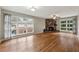 Large living room featuring hardwood floors, a stone fireplace, and large windows at 3826 Ensign Dr, Chamblee, GA 30341