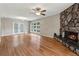 Spacious living room with hardwood floors, a stone fireplace, and a view of the backyard at 3826 Ensign Dr, Chamblee, GA 30341