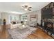 Inviting living room featuring hardwood floors, a stone fireplace, and ample natural light at 3826 Ensign Dr, Chamblee, GA 30341