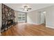 Bright living room featuring hardwood floors, a stone fireplace, and access to the front entrance at 3826 Ensign Dr, Chamblee, GA 30341