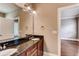 Bathroom vanity featuring double sinks, granite countertop, and large mirror with decorative lighting at 384 16Th Nw St # 1, Atlanta, GA 30363