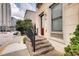 Home entrance featuring brick steps, black railing, and a view of the street at 384 16Th Nw St # 1, Atlanta, GA 30363