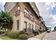 Modern townhome with brick and cream-colored facade, balconies, and manicured landscaping at 384 16Th Nw St # 1, Atlanta, GA 30363
