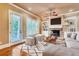 Bright living room with hardwood floors, a fireplace, built-in shelving, and large windows at 384 16Th Nw St # 1, Atlanta, GA 30363