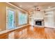 Bright living room with hardwood floors, a fireplace, built-in shelving, and large windows at 384 16Th Nw St # 1, Atlanta, GA 30363