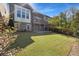 Grassy backyard view of the deck and patio of a brick home at 6454 Meridian Way, Atlanta, GA 30328
