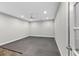 An empty, unfinished basement with grey rubber tile flooring and a ceiling fan at 6454 Meridian Way, Atlanta, GA 30328