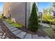 Stone steps up to the side of a brick home with mature landscaping at 6454 Meridian Way, Atlanta, GA 30328