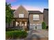 Charming two-story brick home featuring a covered front porch and a two-car garage with updated doors at 6454 Meridian Way, Atlanta, GA 30328